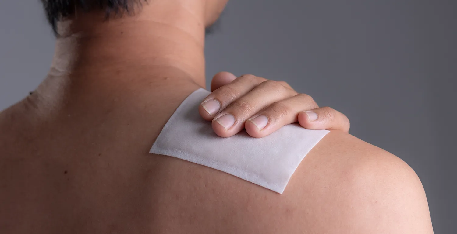 A man with a bandage after skin cyst removal