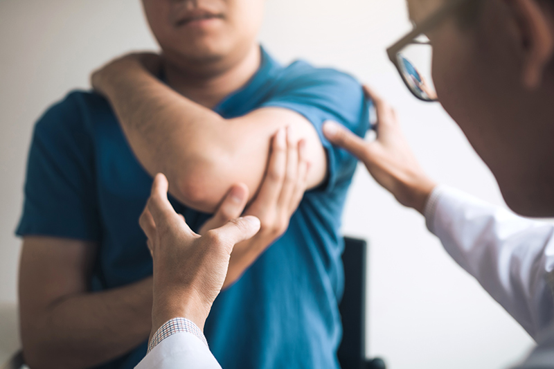 A dermatologist examining a patient’s skin