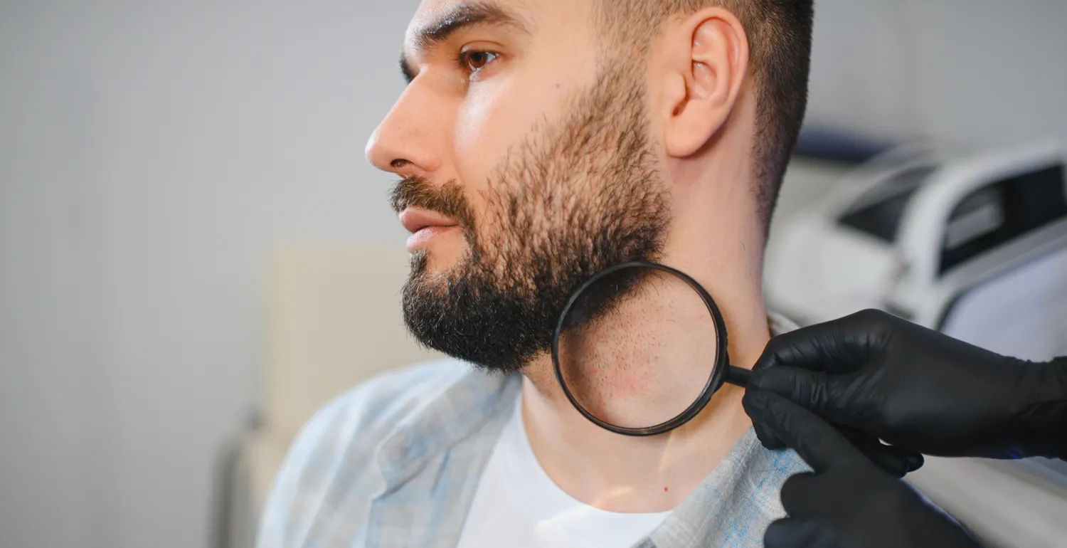 Doctor holding magnifying glass to patient's neck